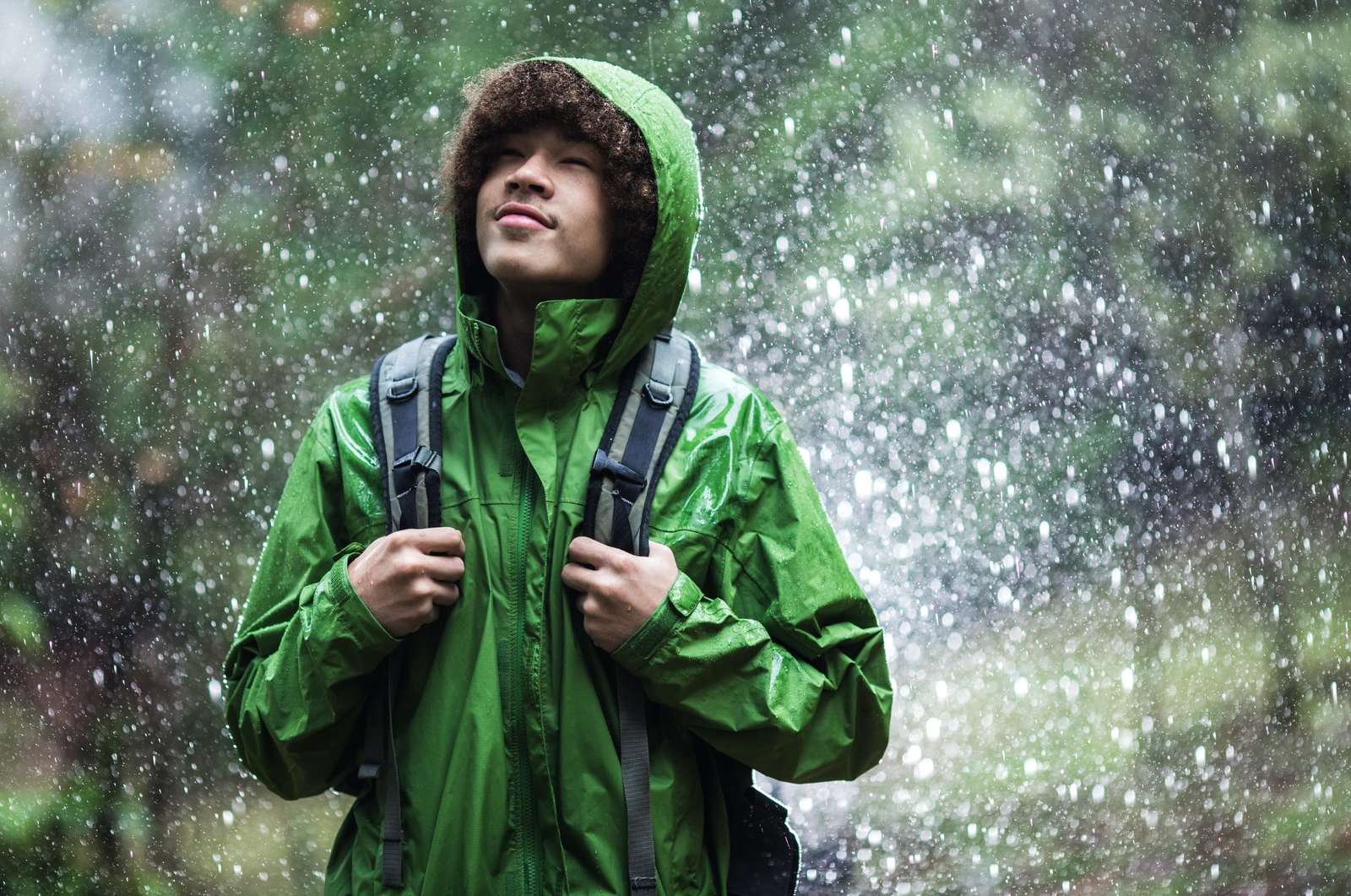 a person in a green raincoat